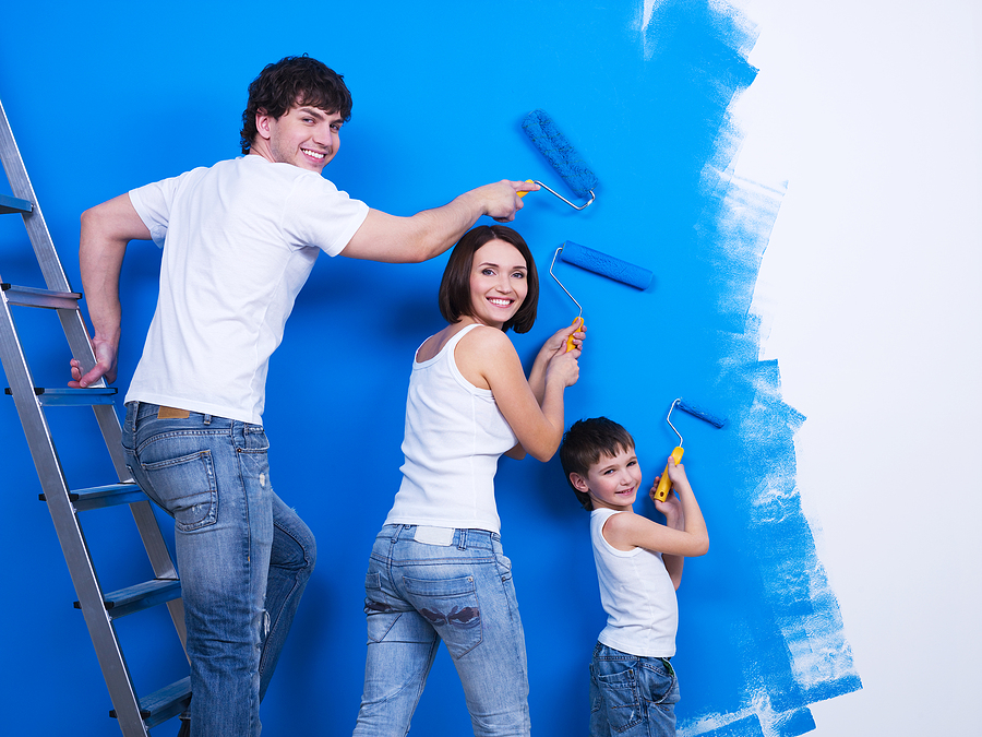 Young Family Painting The Wall