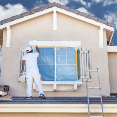 Professional Painter on the roof of a house.